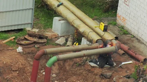 Worker welding metal heating pipes outdoors during pipeline construction Stock Footage 342922581