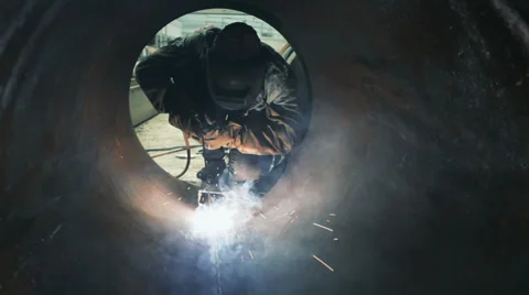 Worker welding metal piping Stock Footage 33960697
