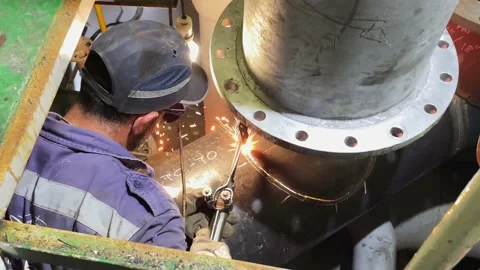 Worker welding metal piping using tig welder Stock Footage 201310561