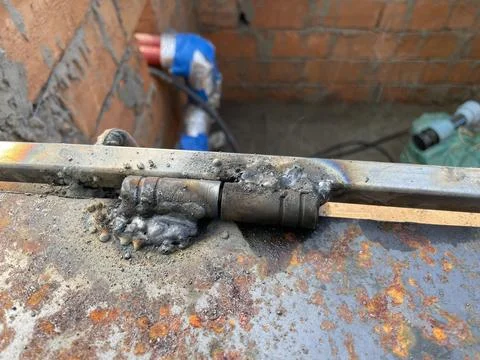 Worker welding metal structure at construction site 库存照片