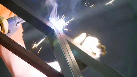 Worker welding metal with welding machine Stock Footage 128929113
