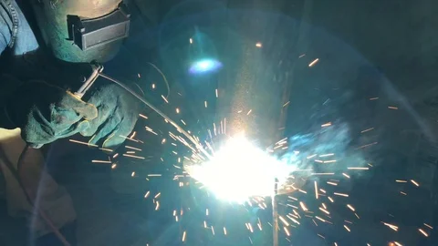 Worker welding piping with fire spark in contruction site. Slow motion Stock Footage 88395695
