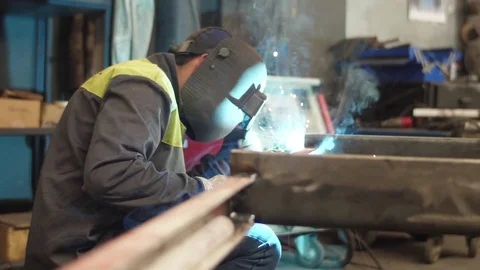 Worker welding steel with mig welder machine slow motion Stock Footage