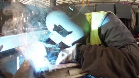 Worker welding steel with mig welder machine slow motion Stock Footage