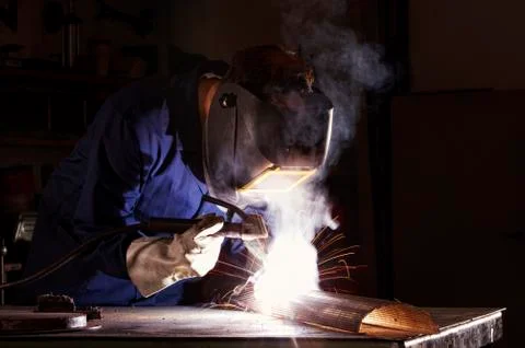 Worker welding in workshop. Stock Photos