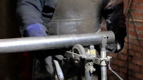 Worker welds an iron part Stock Footage 93830293