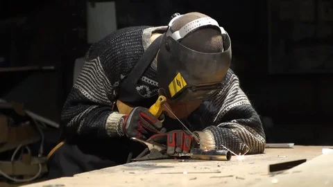 Worker welds an iron pipe Stock Footage 126932390