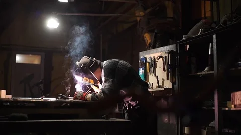 Worker welds an iron pipe Stock Footage 126932430