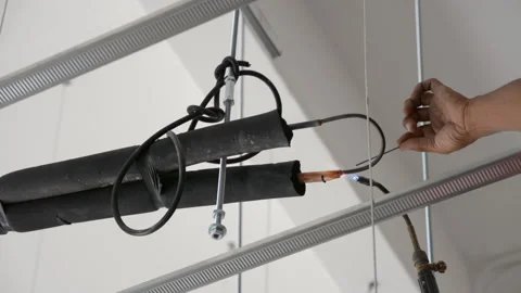 Worker welds joint of copper pipe air conditioner Stock Footage 277564882