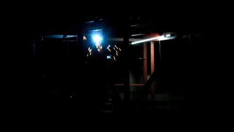 Worker welds metal a hangar Stock Footage 276581174