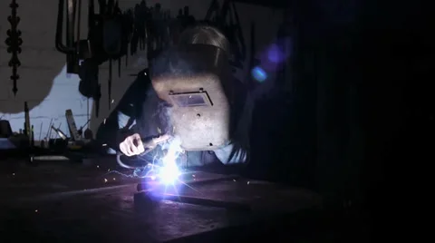 A worker welds in a old Workshop -  mystical atmosphere Stock Footage 39550433