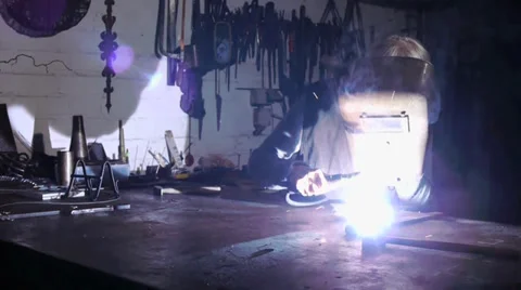A worker welds in a old Workshop -  mystical atmosphere Stock Footage 39550521