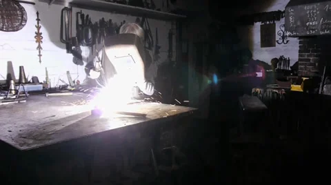 A worker welds in a old Workshop -  mystical atmosphere Stock Footage 39550581