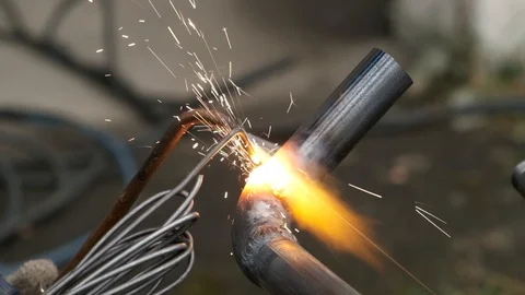 Worker welds pipe gas welding. Closeup. sparks flying around flame. fuel gase Stock Footage 117080702