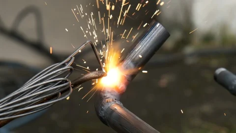 Worker welds pipe gas welding. Closeup. sparks flying around flame. Industria Video stock 117082677