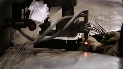 Worker welds reinforcement construction with spot welding Stock Footage 70208189