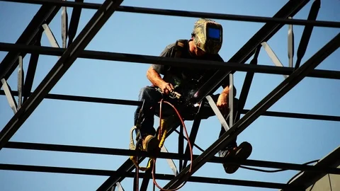 Worker welds steel on building Stock Footage 73777475