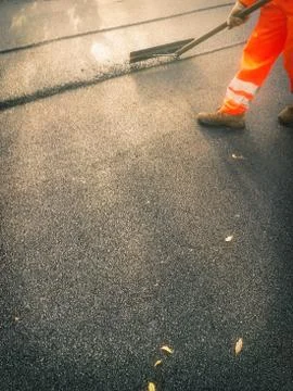Worker while asphalt a road Stock Photos