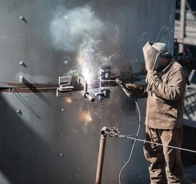 Worker while doing a industrial welding outdoor Stock Photos