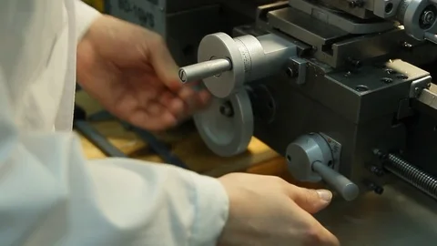 The worker in a white coat adjusts the lathe Stock Footage 84785437