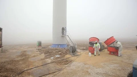 Worker in White Coveralls Walking From Right to Left Stock Footage 72316498