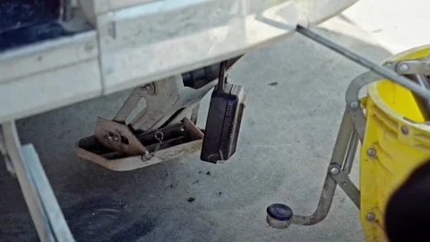 A worker winding up a stabiliser leg on a mobile coffee cart, retracting the 스톡 동영상 332614247