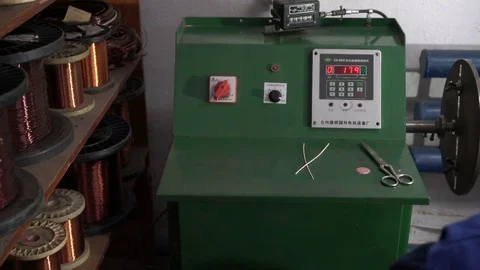 The worker winds the winding of the electric motor. The machine for winding Stock Footage 75151121