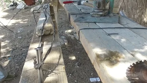 The worker winds the wire on the nails. Stock Footage 77291807