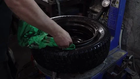 The worker wipes the wheels of grease Stock Footage 84284339