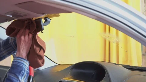 The worker wipes the windshield of the car with a special towel Stock Footage 106030144