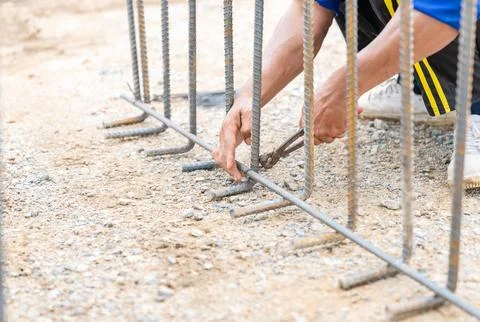 Worker wire bundle deformed reinforcement. Stock Photos