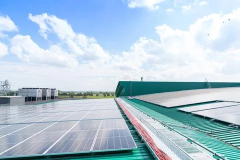 Worker wiring sola cell cable on roof top factory. Stock Photos