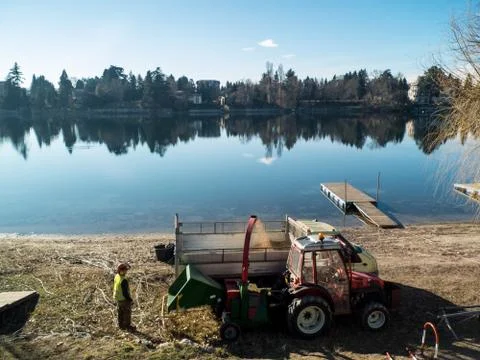 Worker at work along the river Ticino in Sesto calende Italy, tractor and tru Stock Photos