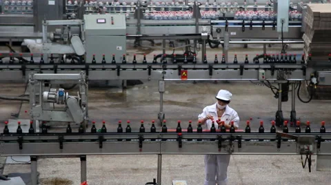 Worker working on assembly line of filling and packaging Shanxi mature vinegar Stock Footage