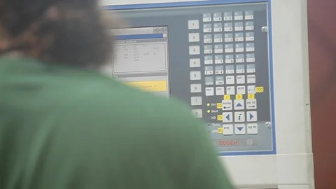 Worker working on a computer interface in a factory. Green Shirt. Stock Footage 110771794