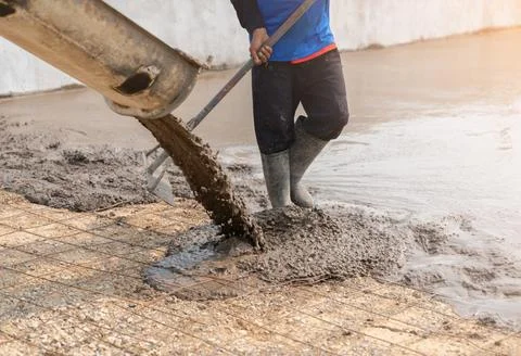 Worker working for concrete pavement for ground road. Stock Photos