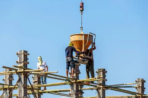 Worker working in construction on blue sky Stock Photos