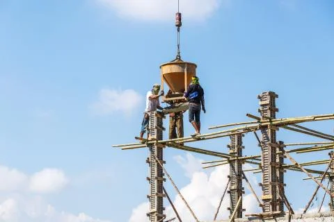 Worker working in construction on blue sky Stock Photos