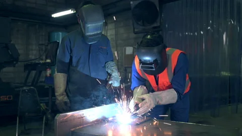 The worker working in the factory via the welding machine. Stock Footage 142950511