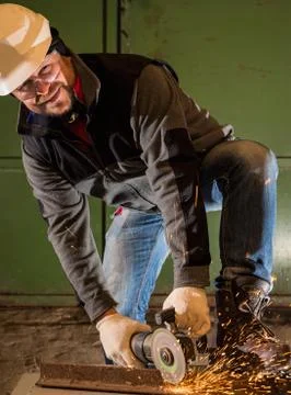 Worker working of a grinding machine Stock Photos