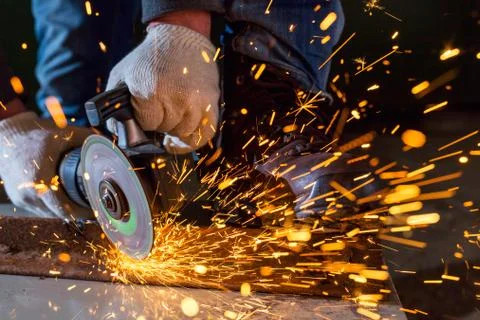 Worker working of a grinding machine Stock Photos