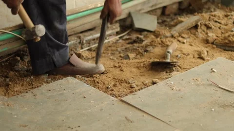 Worker working hard, removing tiles, using hammer and chisel Stock Footage 245092524