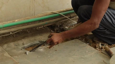Worker working hard, removing tiles, using hammer and chisel Stock Footage 245092590