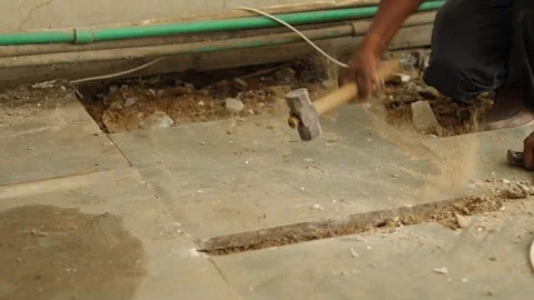 Worker working hard, removing tiles, using hammer and chisel Stock Footage 245092817