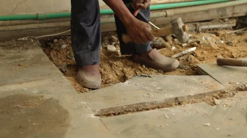 Worker working hard, removing tiles, using hammer and chisel Stock Footage 245092915