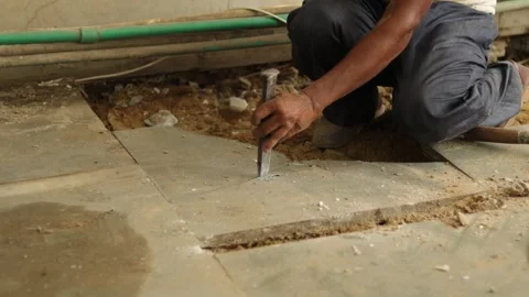 Worker working hard, removing tiles, using hammer and chisel Stock Footage 245092963