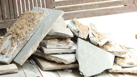 Worker working hard, removing tiles, keeping aside tiles. Stock Footage 245093948