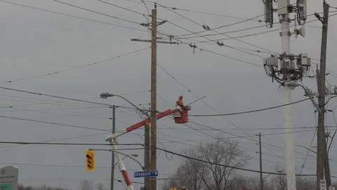 Worker working on high voltage electrical power lines in city Stock Footage 146106122