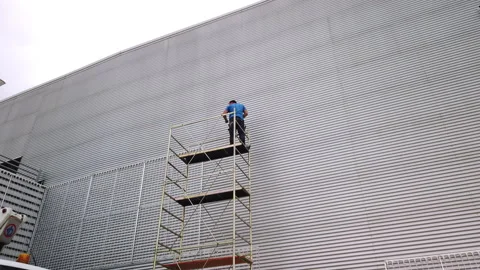 Worker working on scaffolding. Concept of safety at work Stock Footage 254604472