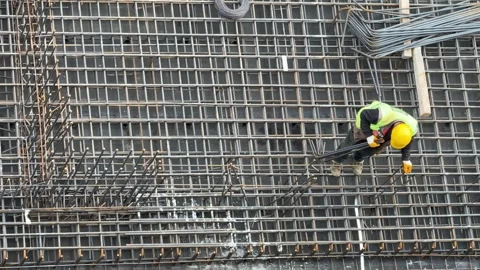 Worker Working on Steel Mesh Reinforcement and Construction Preparation Stock Footage 333008419